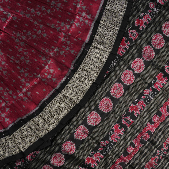 Detailed close-up of the maroon and black Sambalpuri silk saree's luxurious fabric texture and weave.