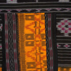 Professional styling of the yellow and black Sambalpuri cotton saree with traditional motifs shown on a model.