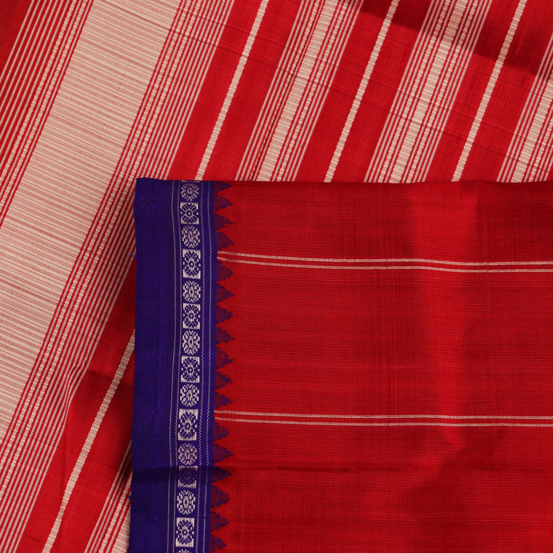 Close-up view of the intricate silk texture on a Berhampuri saree in white with a red border