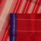 Close-up view of the intricate silk texture on a Berhampuri saree in white with a red border