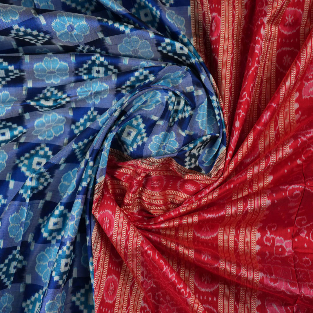 Close-up of the luxurious silk fabric texture and distinctive Sambalpuri ikat weave of the blue Pasapalli saree.