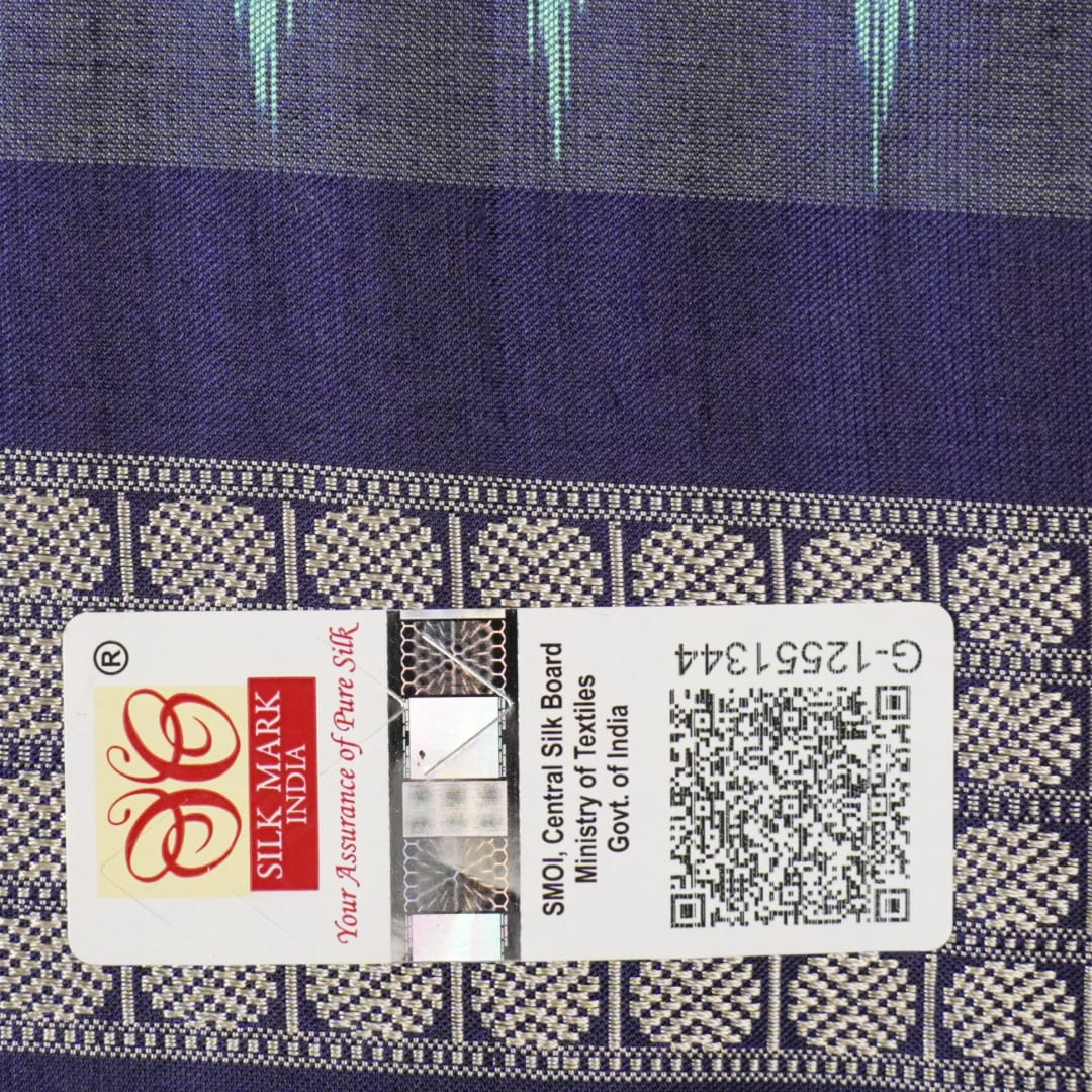 Extreme close-up revealing the rich texture and intricate weave of green Bomkai Silk fabric.