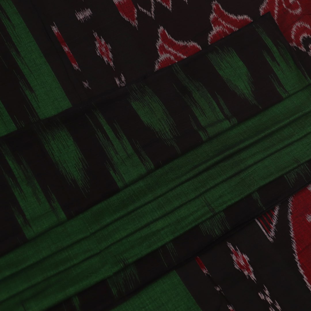 Green and black plain Sambalpuri cotton saree gracefully draped on a model, highlighting its elegant styling.