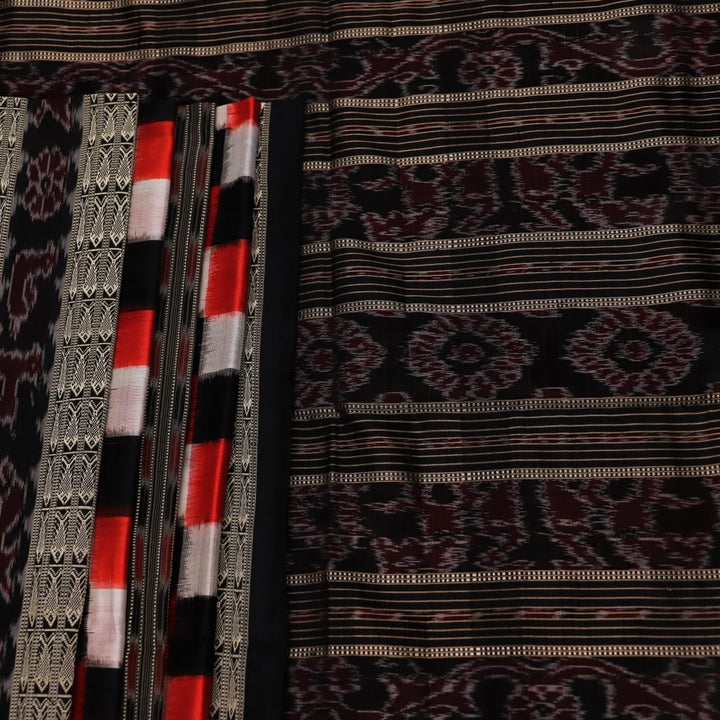 Close-up view of the smooth, lustrous texture of black silk fabric with a Pasapalli pattern in the Sambalpuri style