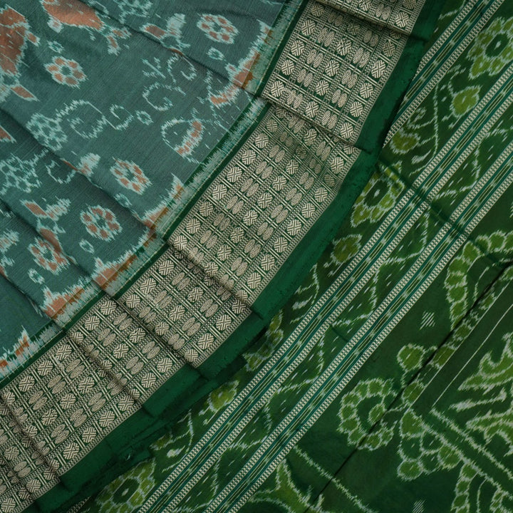 Ultra close-up of green Sambalpuri silk saree fabric, highlighting its luxurious texture and weave.