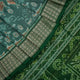 Ultra close-up of green Sambalpuri silk saree fabric, highlighting its luxurious texture and weave.