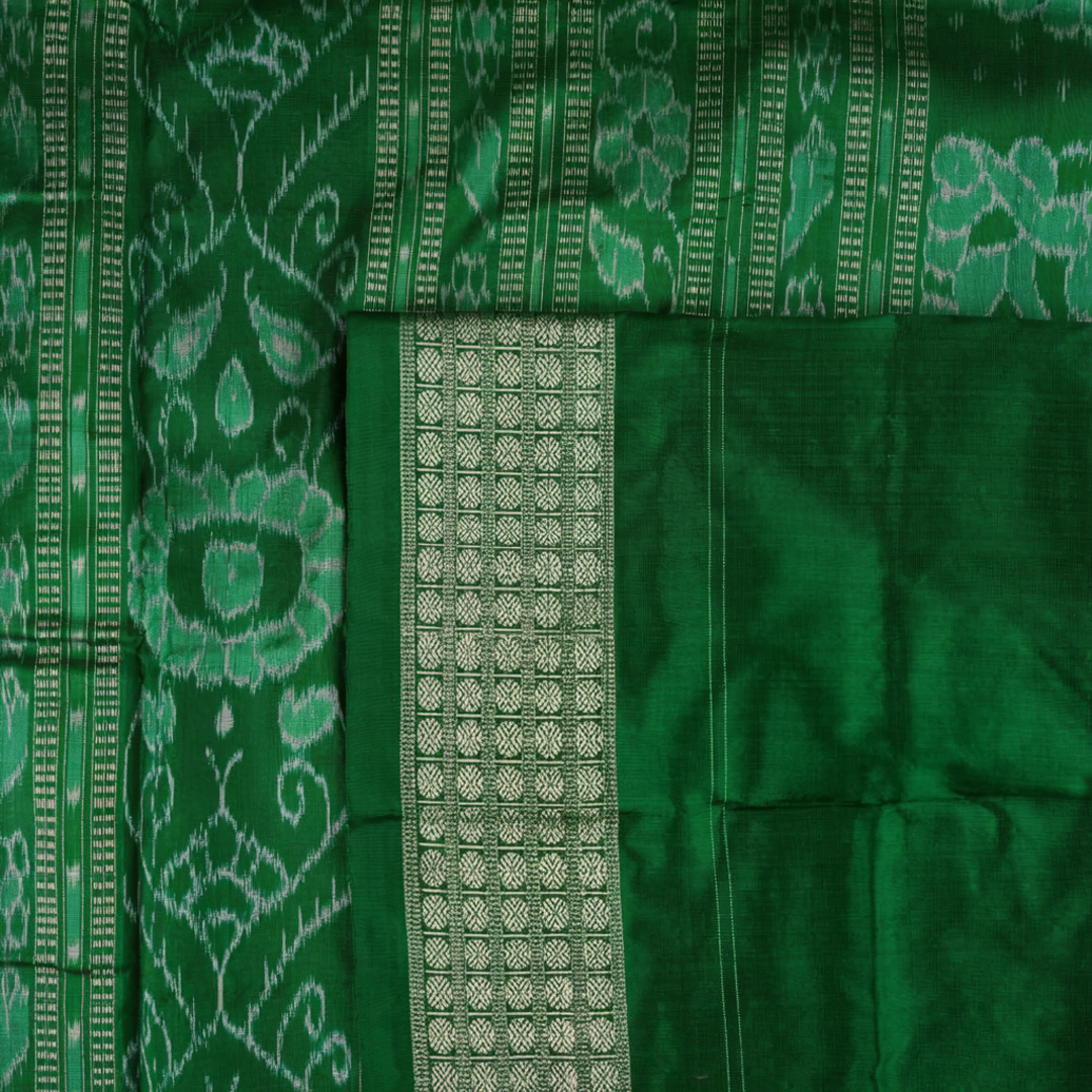 Close-up of the smooth, rich silk texture of the peach Sambalpuri saree with fine motifs.