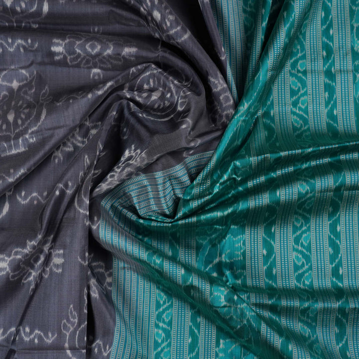 Extreme close-up of grey Sambalpuri silk fabric, revealing its fine handloom texture and weave quality.