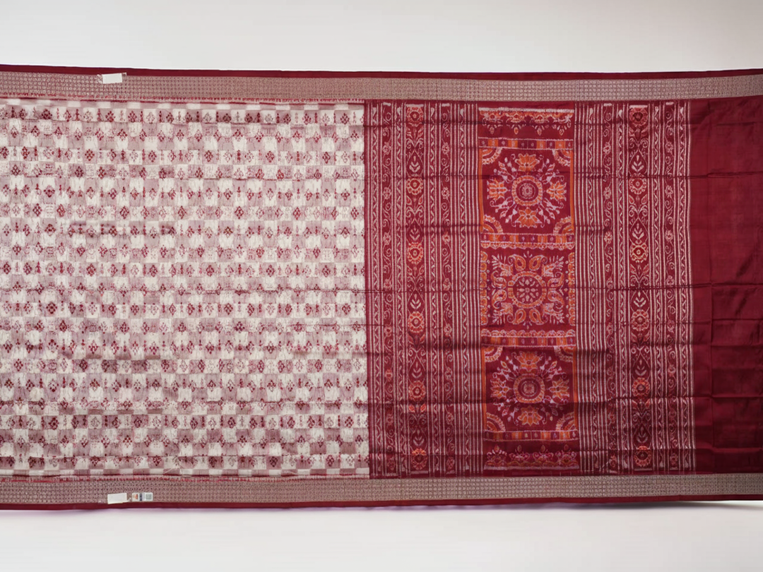 Close-up of the Sambalpuri silk saree fabric, detailing its luxurious texture and fine handloom weave.