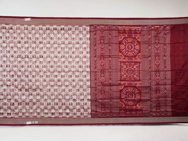 Close-up of the Sambalpuri silk saree fabric, detailing its luxurious texture and fine handloom weave.