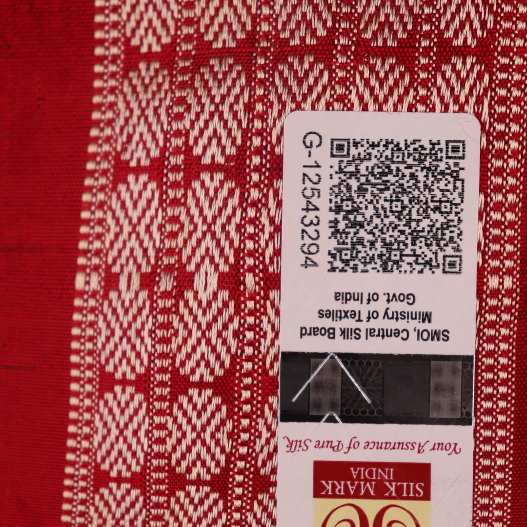 Close-up of grey Sambalpuri silk saree fabric showing intricate motif texture.