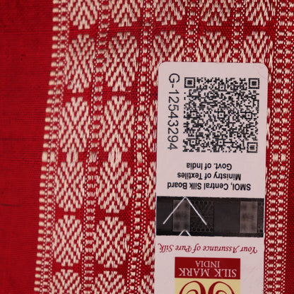 Close-up of grey Sambalpuri silk saree fabric showing intricate motif texture.