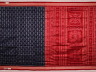 Close-up view of the blue silk Sambalpuri saree's fabric texture showcasing intricate motifs in red