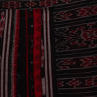 Red and black Sambalpuri cotton saree draped, showcasing overall styling and motifs.