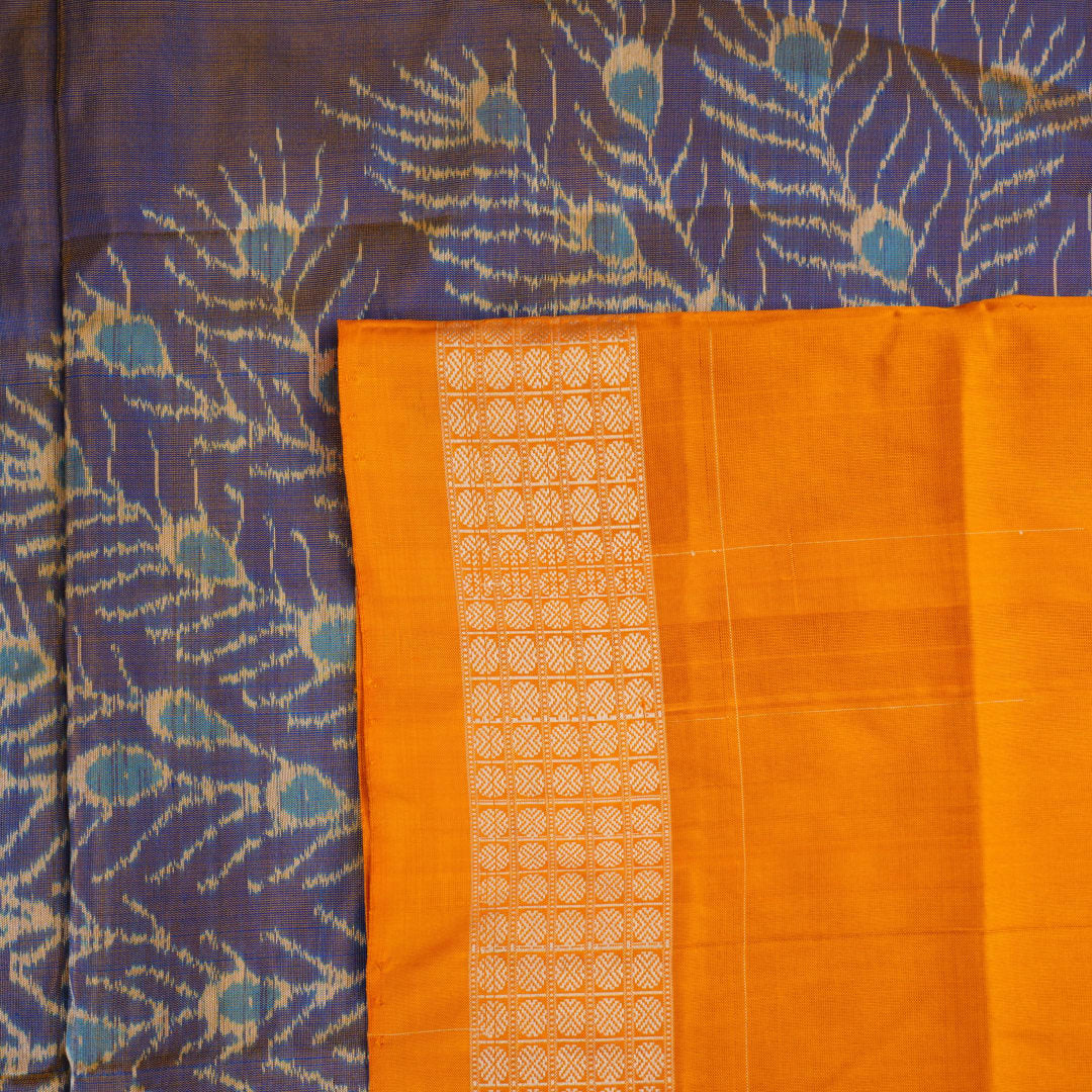 Close-up of the luxurious Sambalpuri silk fabric, highlighting its rich texture and handloom weave in blue and yellow.