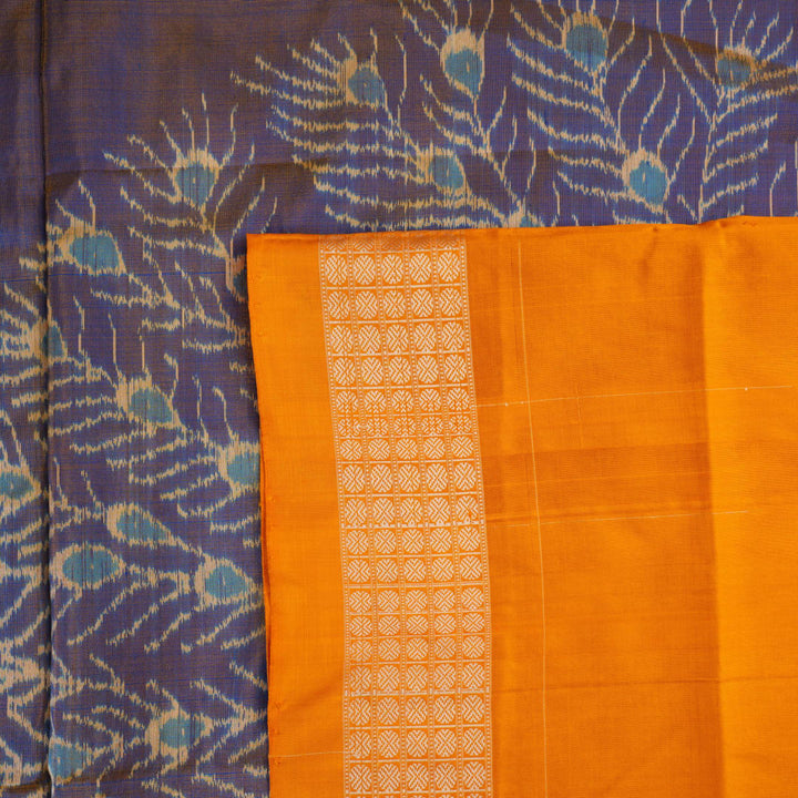 Close-up of the luxurious Sambalpuri silk fabric, highlighting its rich texture and handloom weave in blue and yellow.