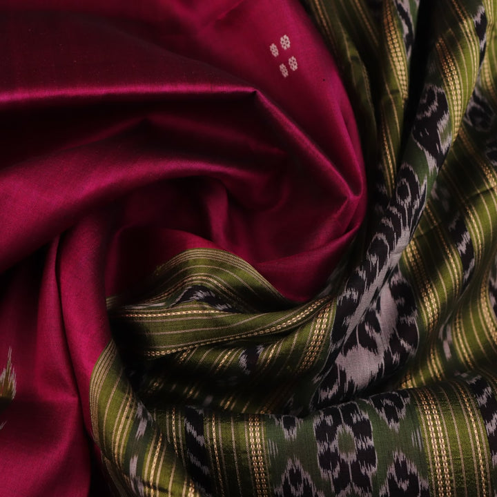 Magenta Khandua silk saree styled; green blouse accentuates the butta pattern and rich drape.