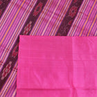 Close-up of plain green and pink Sambalpuri silk saree fabric texture.