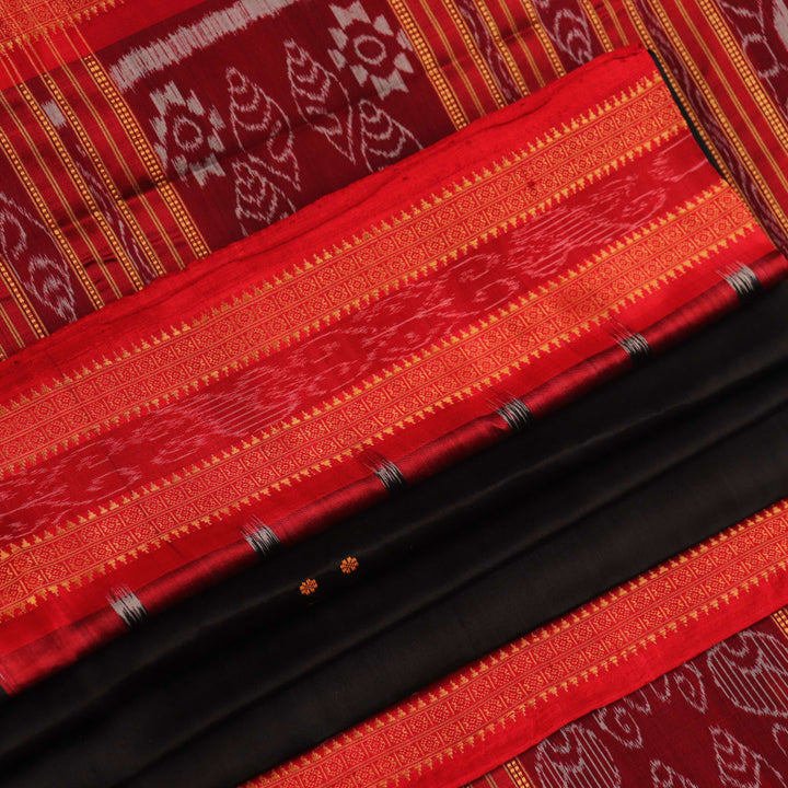 Draping view of a black Khandua silk saree with a red border and butta pattern