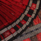 Detailed texture of handwoven Bomkai silk saree fabric in maroon and black with butta pattern.