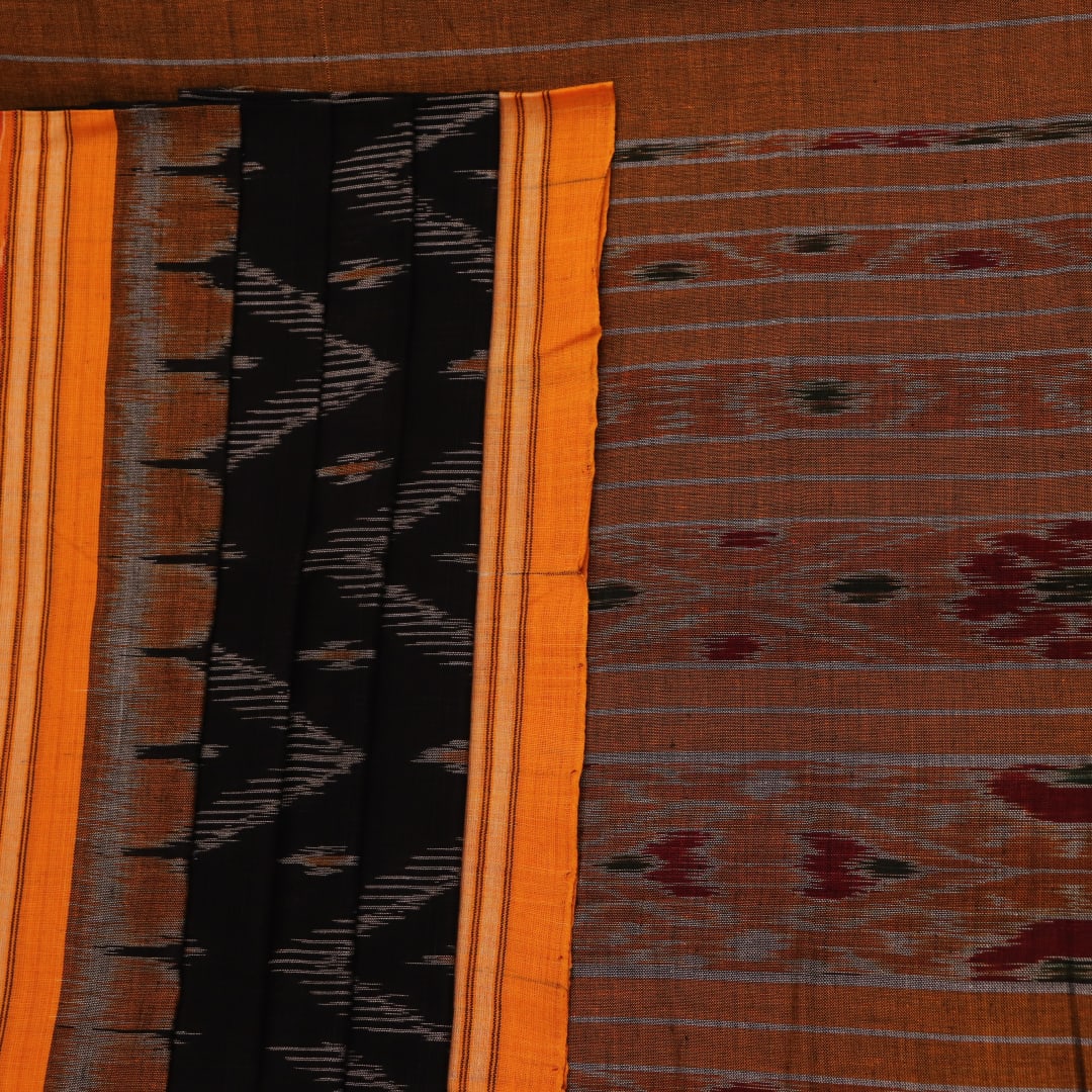 Black and yellow cotton Sambalpuri saree with motifs, styled and draped elegantly