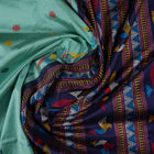 Extreme close-up revealing the rich texture and intricate weave of green Bomkai Silk fabric.