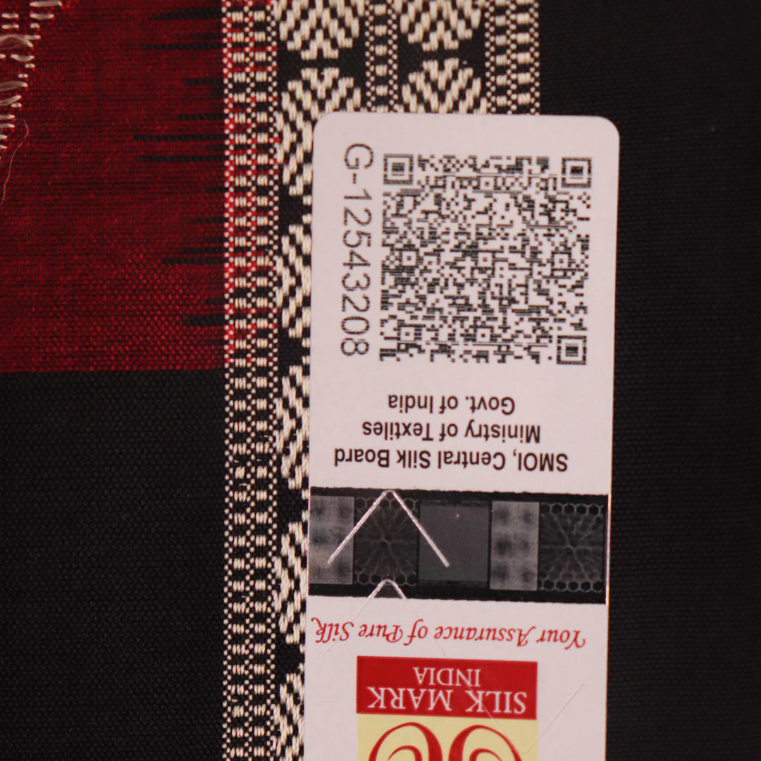Detailed texture of handwoven Bomkai silk saree fabric in maroon and black with butta pattern.