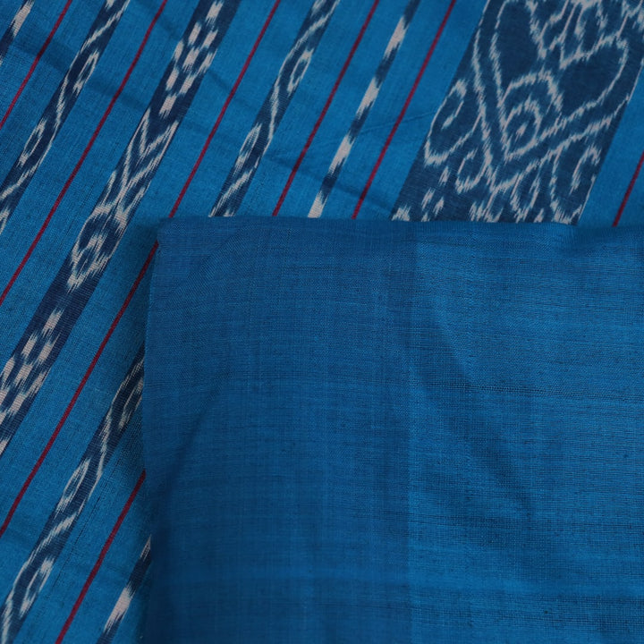 Close-up shot showcasing the textured weave of the tussar silk fabric of a plain pink and blue saree.