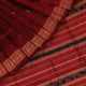 Close-up of maroon Sambalpuri Silk Saree fabric, showing intricate butta weave texture.