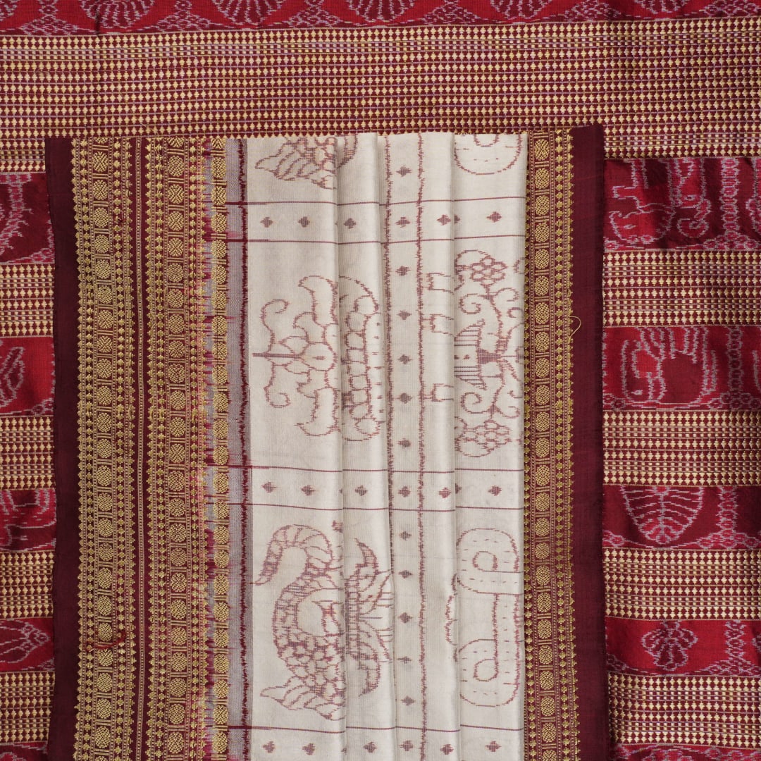 Close-up of the fine silk texture of the white Sambalpuri saree, highlighting its soft sheen and weave.