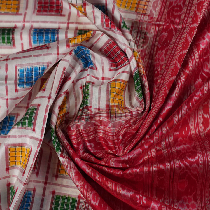 Close-up of the luxurious white Sambalpuri silk saree fabric, highlighting its rich texture and weave.