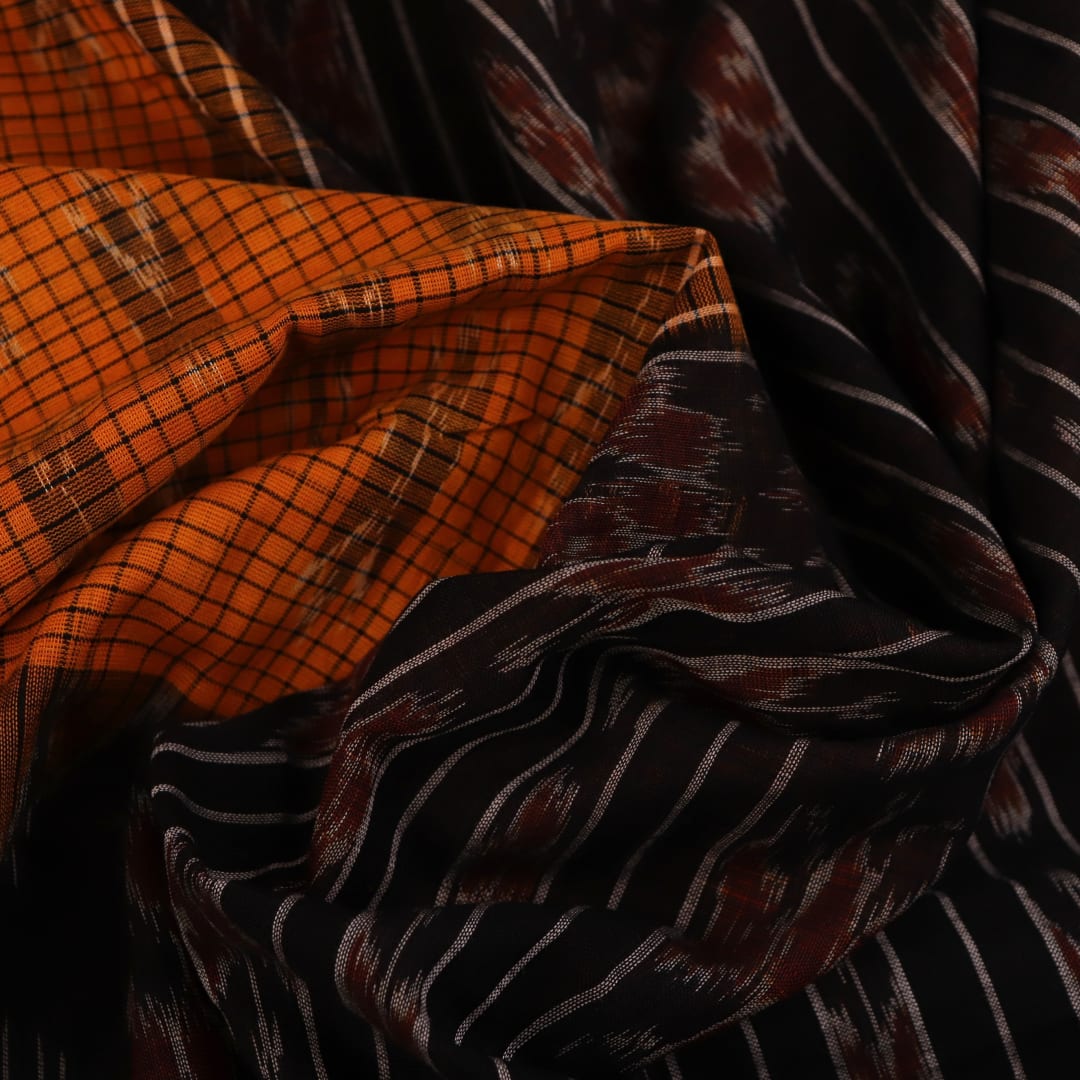 Woman draped in a yellow and black Sambalpuri cotton saree, showcasing the stylish drape and motif pattern.