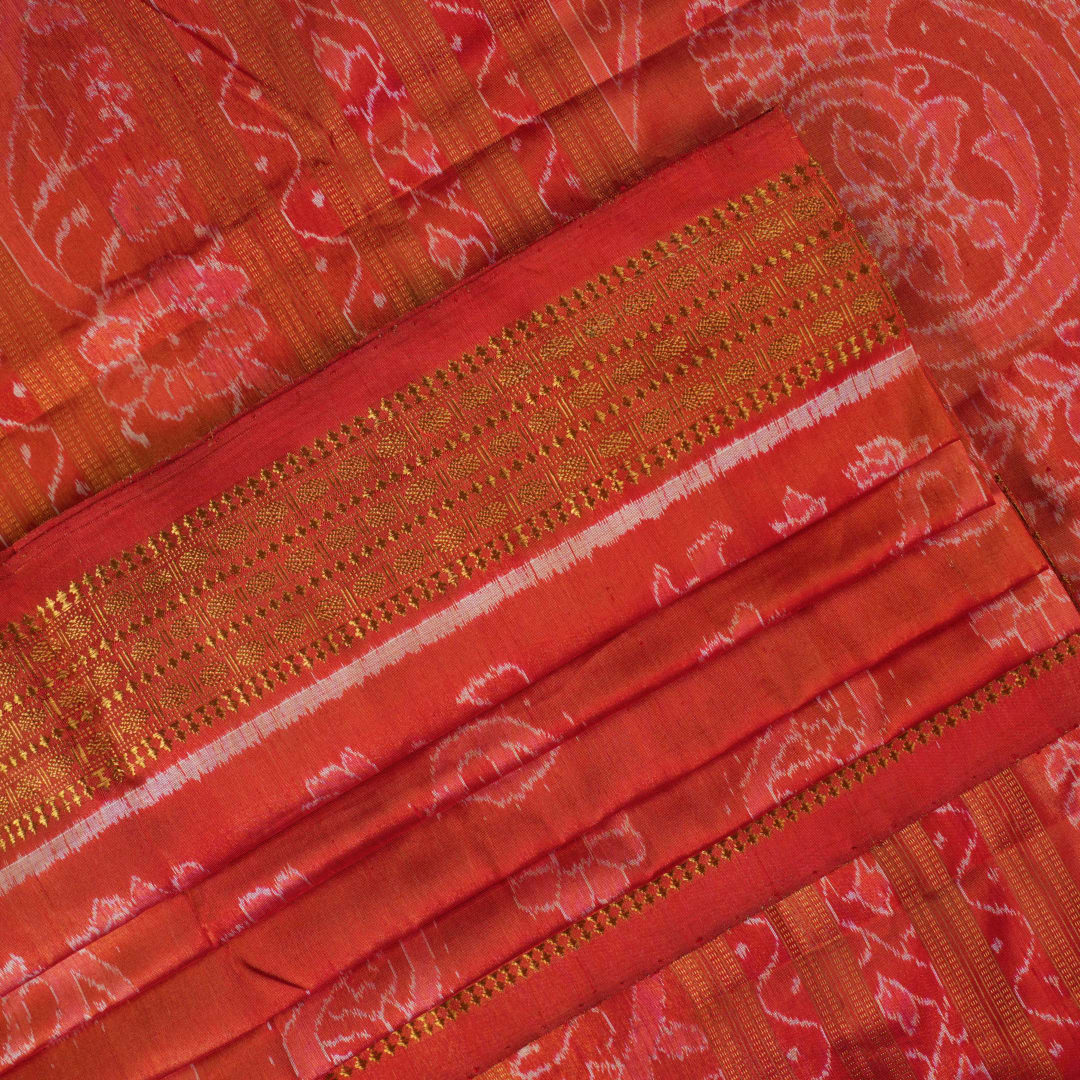 Close-up of rust Sambalpuri silk fabric, revealing its luxurious texture and fine handloom weave.