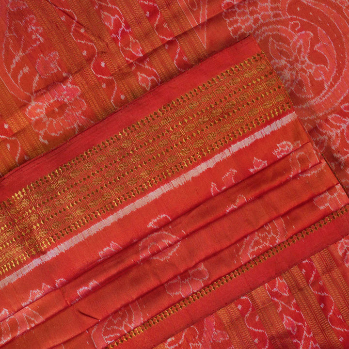 Close-up of rust Sambalpuri silk fabric, revealing its luxurious texture and fine handloom weave.