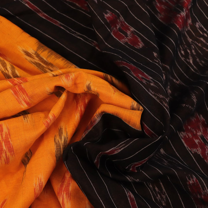 Styling shot showcasing a draped yellow and black Sambalpuri cotton saree with motif details.