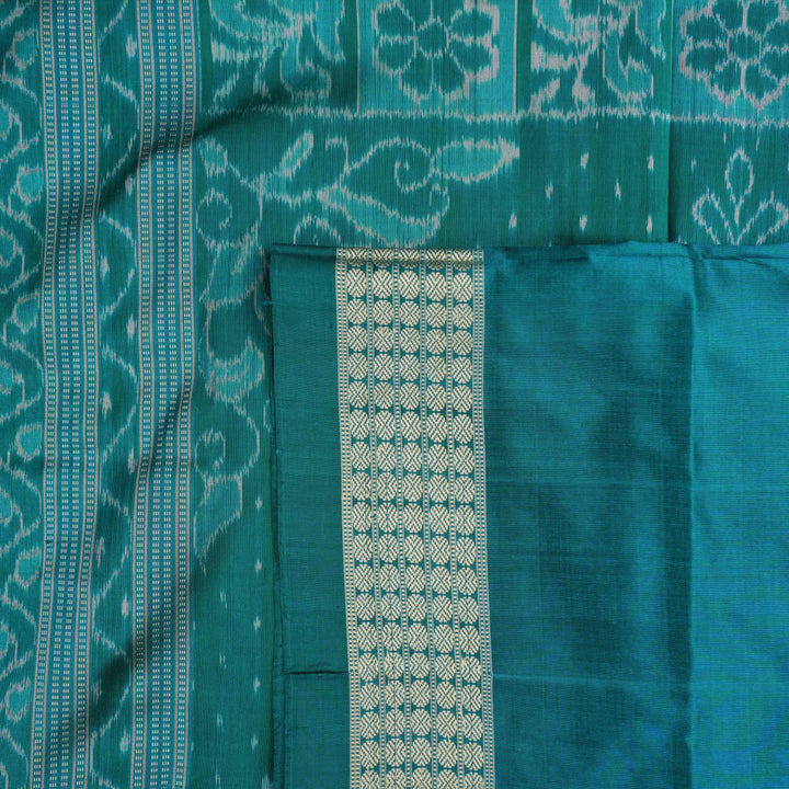 Extreme close-up of grey Sambalpuri silk fabric, revealing its fine handloom texture and weave quality.