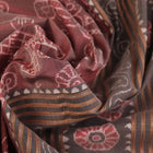 Close-up of a multicolored silk Sambalpuri saree fabric showing the intricate handloom texture and motifs.