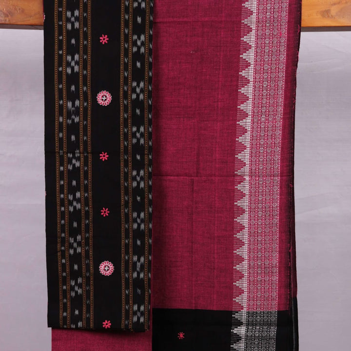 Close-up of blouse piece featuring intricate Sambalpuri motifs in black and magenta on a cotton base.