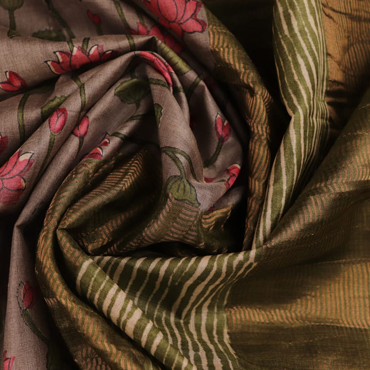 Close-up view of grey Tussar silk saree with intricate motifs on its textured fabric