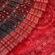 Close-up of grey Sambalpuri silk saree fabric showing intricate woven motifs and texture.