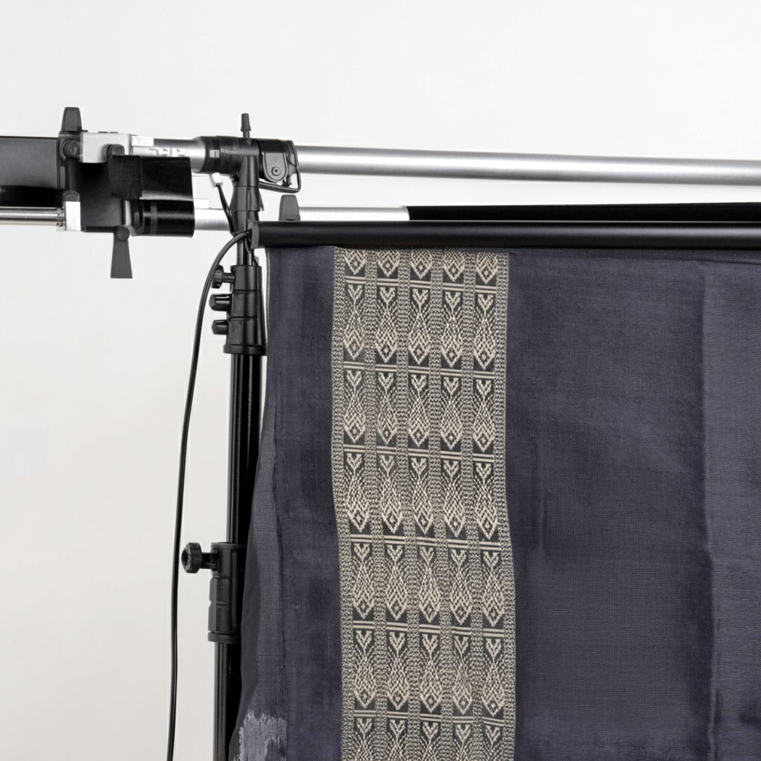 Close-up of the soft, luxurious grey Sambalpuri silk fabric texture with subtle weave details.