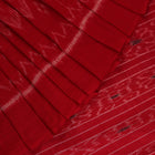 Cream and red Sambalpuri cotton saree with motifs elegantly draped on a person.