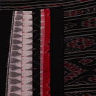 Saree styling: A red and black Sambalpuri cotton handloom saree with motifs is beautifully draped.