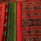 Green Khandua silk saree draped, showcasing its butta pattern and red accents.