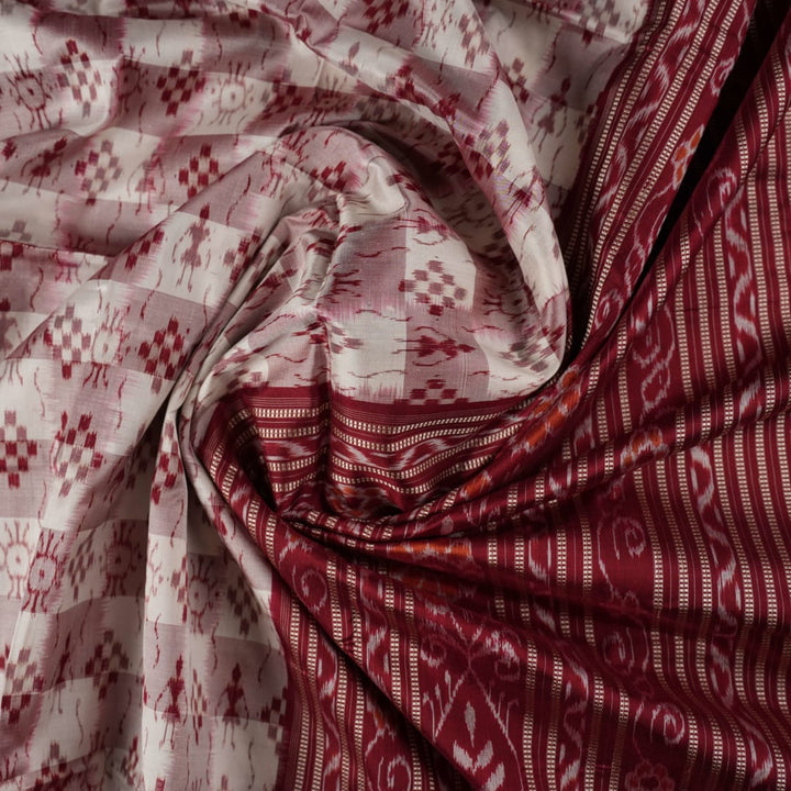 Close-up of the Sambalpuri silk saree fabric, detailing its luxurious texture and fine handloom weave.