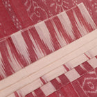 Model wearing a white and maroon Sambalpuri cotton saree with motifs, demonstrating a stylish drape.