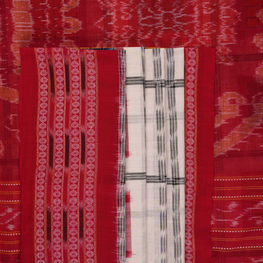 Model wearing a white and red Sambalpuri cotton saree with traditional motifs, styled for an elegant look.