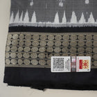 Close-up of grey & black Sambalpuri silk saree fabric, highlighting its rich texture and weave.