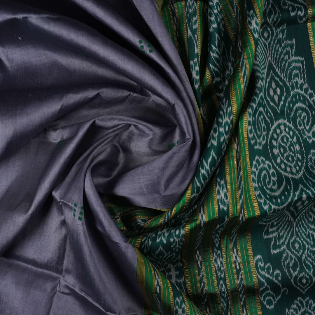 Model draped in a grey and green Khandua silk saree with butta pattern for a classic traditional look.