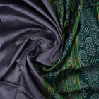 Model draped in a grey and green Khandua silk saree with butta pattern for a classic traditional look.